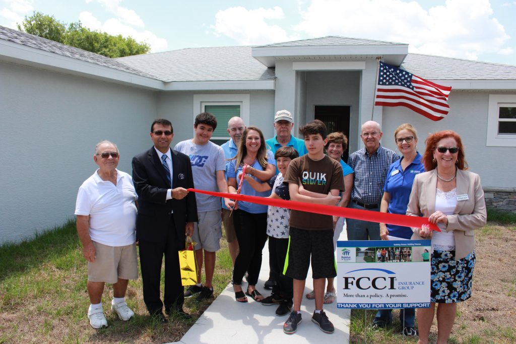 Members from FCCI with a Habitat Sarasota homeowner at her home dedication.